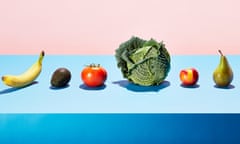 A row of different fruits and vegetables on a table top<br>The composition references a conveyor belt or production line