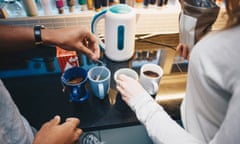 Young adults making tea and coffee