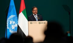 Gustavo Petro stands at a lectern with the UN and the UAE flag to his left