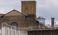 Exterior view of barbed wire fencing and walls surrounding HMP Wandsworth