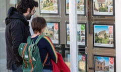 People looking in an estate agents windows in Ely, Cambridgeshire