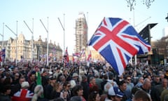 A union jack flag is waved in Parliament Square in Westminster