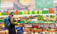 A shopper in the fruit and vegetable section of a Lidl supermarket. 