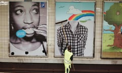 Worker putting up advertise in the subway