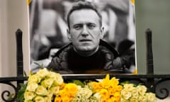 Flowers and a picture are left as a tribute to Russian politician Alexi Navalny, near to the Russian Embassy in London on 18 February 2024