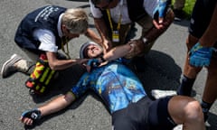 Britain's Mark Cavendish receives medical assistance after crashing during the eighth stage of the Tour de France