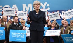 Prime Minister Theresa May speaks to party supporters in front of the Conservative party’s battlebus.