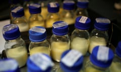 Rows of small blue-capped glass bottles containing milk.