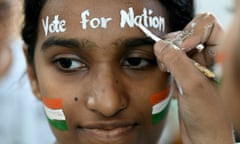 An art school student gets her face painted with the Indian flag and a message reading 'Vote for the Nation'