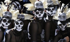 Men dressed in costumes wait for a Day of the Dead parade to begin along Mexico City’s main Reforma Avenue on Saturday.
