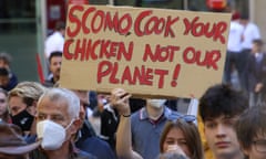 Protesters at the School Strike 4 Climate in Sydney hold a sign that reads 'Scomo, cook your chicken not our planet!'