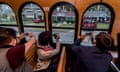 People on the Big D Fun Tours JFK Trolley take photos of the house on Beckley Avenue where Lee Harvey Oswald lived. 