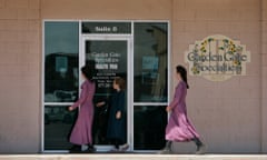 Young girls dressed in traditional clothing made in pastel colors walk into a store in Colorado City, Arizona on Aug. 29, 2006. Warren Jeffs, spiritual leader of the Fundamentalist Church of Latter Day Saints was arrested in Nevada sending the national media to the small community famous for the practice of polygamy. (AP Photo/Laura Rauch)