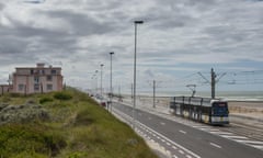 The Belgum, Coastal Tram, the Kusttram on its journey by the sea on a cloudy and blue-sky day.