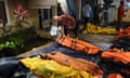 A resident looks into body bags searching for a relative missing after the tsunami that hit the Sunda Strait 