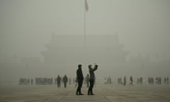 A visitor (centre R) takes a photo in Tiananmen Square during heavy pollution in Beijing on December 1, 2015. Beijing ordered hundreds of factories to shut and allowed children to skip school as choking smog reached over 25 times safe levels on December 1, casting a cloud over China's participation in Paris climate talks. AFP PHOTO / WANG ZHAOWANG ZHAO/AFP/Getty Images