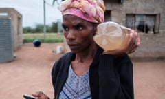 Siphesiwe ‘Minky’ Sithole, 40, with a bottle of water that she carried back from a river