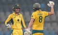 Australia's Phoebe Litchfield, left, celebrates after scoring 50 runs with her team player Ellyse Perry during the first one day international cricket match between India and Australia in Mumbai, India, Thursday, Dec. 28, 2023. (AP Photo/Rafiq Maqbool)