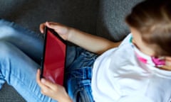 Little girl in protection mask using tablet