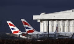 Sunlight illuminates the tailfins of British Airways aircraft at Terminal 5 in Heathrow airport