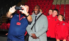 Sol Campbell, the new manager of Macclesfield Town, poses for a picture with Exeter City mascots before the match.