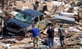 Local residents walk among the debris from tornado damaged homes, Wednesday, May 22, 2024, in Greenfield, Iowa. (AP Photo/Charlie Neibergall)