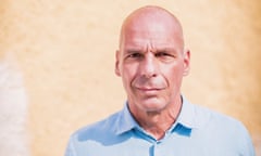 Yanis Varoufakis against a stone wall