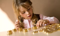 young girl counting her money on table