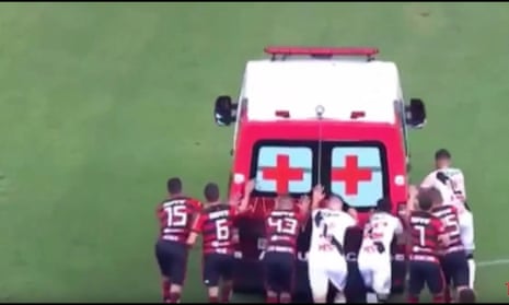 Footballers push ambulance from pitch in Brazil after it fails to start – video 