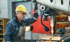 Older man using a drill press