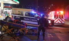 Police and emergency workers descend on a petrol station in Tijuana last month after a drive-by shooting left four men injured, one critically.