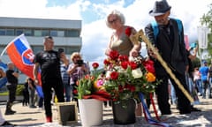 Hospital building and people with flowers and flag