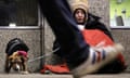 Dawn, a homeless woman from north Wales, sits huddled under a sleeping bag next to her dog in London