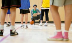 Teacher ticks a checklist in a PE class