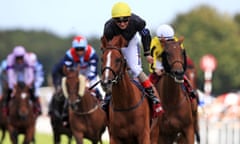 Andrea Atzeni celebrates winning his third race of the day on Stradivarius in the Goodwood Cup with Big Orange, right, in second.