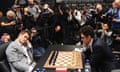 Magnus Carlsen (L) plays against Fabiano Caruana (R) during the World Chess Championship 2018 in London on 26 November 2018