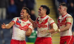 Moses Mbye (left) celebrates scoring St Helens’ third try with teammates Sione Mata'utia (centre) and Lewis Dodd against Leeds.