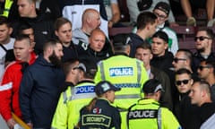 Police move into the crowd at Turf Moor after Hannover fans charged towards home supporters during the first half of Saturday’s friendly.