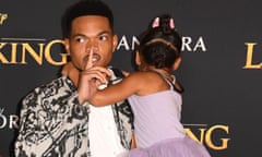 US-ENTERTAINMENT-MOVIE-DISNEY-LION KING<br>US rapper Chance The Rapper (R) gestures to photographers as he and wife Kristen Corley and their daughter arrive for the world premiere of Disney’s “The Lion King” at the Dolby theatre on July 9, 2019 in Hollywood. (Photo by Robyn Beck / AFP)ROBYN BECK/AFP/Getty Images