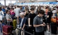 Passengers queue at Gatwick airport amid a global IT outage caused by a defect in a software update last Friday.
