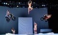 Naked performers on stage, some on motorbikes, hang from the roof