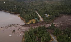 An aerial view of the aftermath of a landslide showing how the highway is cut into two.