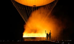 The torchbearers Marie-Jose Perec and French judoka Teddy Riner arrive to light the cauldron and open the 2024 Olympic games.