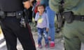 Border Patrol Agents Detain Migrants Near US-Mexico Border<br>MCALLEN, TX - JUNE 12:  A Mission Police Dept. officer (L), and a U.S. Border Patrol agent watch over a group of Central American asylum seekers before taking them into custody on June 12, 2018 near McAllen, Texas. Local police officers often coordinate with Border Patrol agents in the apprehension of undocumented immigrants near the border. The immigrant families were then sent to a U.S. Customs and Border Protection (CBP) processing center for possible separation. U.S. border authorities are executing the Trump administration's "zero tolerance" policy towards undocumented immigrants. U.S. Attorney General Jeff Sessions also said that domestic and gang violence in immigrants' country of origin would no longer qualify them for political asylum status.  (Photo by John Moore/Getty Images)