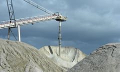 Lithium ore falls from a chute into a stockpile