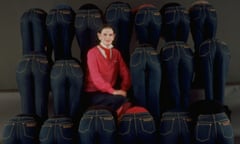 Jeans that ‘really hug your derrière’ … Gloria Vanderbilt sitting amidst a group of models in her designer jeans.