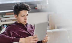 A young man reading a tablet