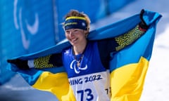 Oleksandra Kononova celebrates with the Ukraine flag after winning her country’s 10th gold of these Games.