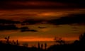 People stand atop a rock formation to watch the sunset in Phoenix on Sunday.