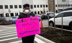 The spread of the coronavirus disease (COVID-19) in New York<br>Jordan Flowers holds a sign at Amazon building during the outbreak of the coronavirus disease (COVID-19), in the Staten Island borough of New York City, U.S., March 30, 2020. REUTERS/Jeenah Moon